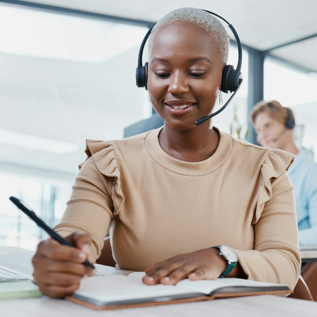 CRM, notebook and planning telemarketing consultant woman writing strategy, solution or idea with s