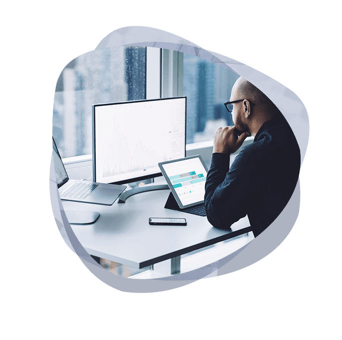 An ethical hacker running an external pentest on a laptop and monitor