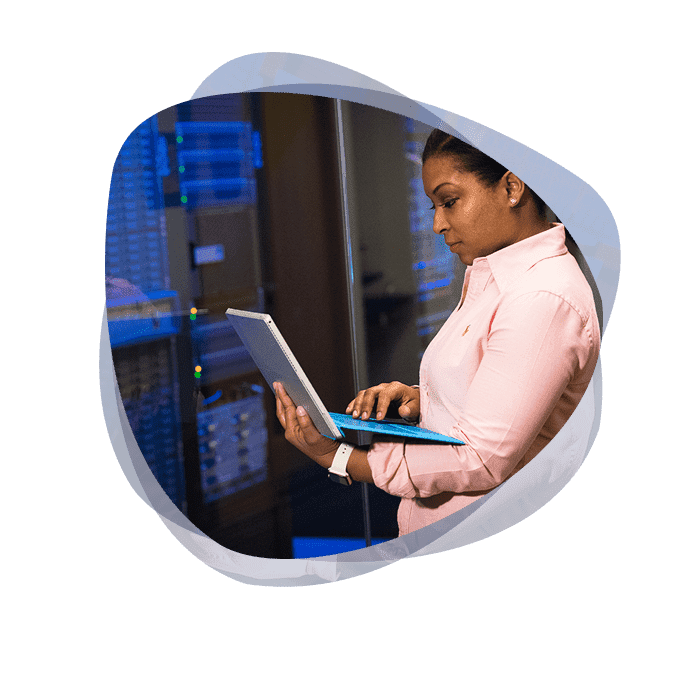 A cyber security specialist assesses an MDR dashboard on her laptop.