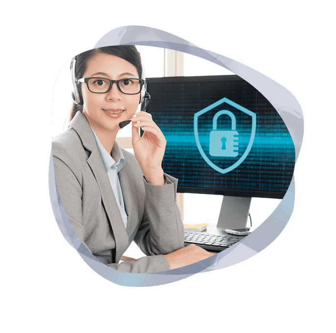 Managed XDR services consultant next to computer monitor.