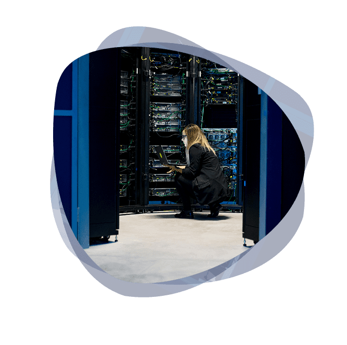 An ethical hacker conducting an onsite pentest, while crouched in a room with a company's servers.