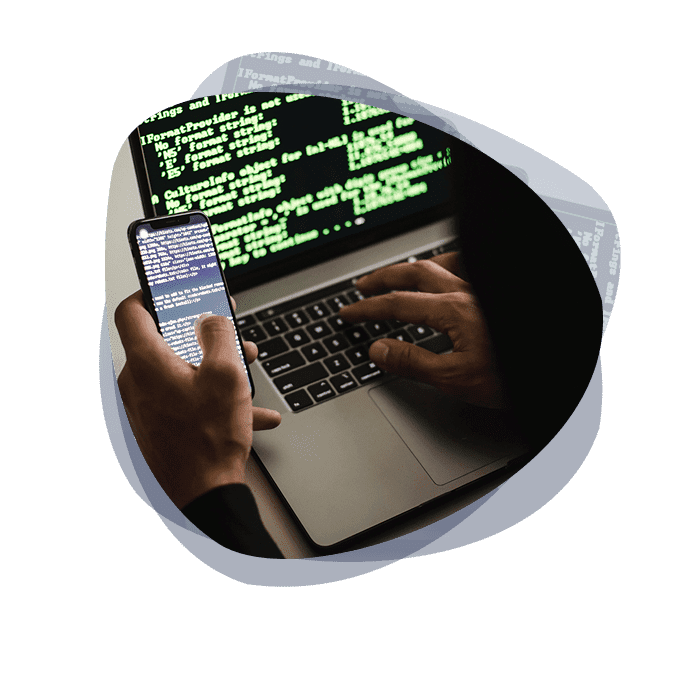 Ethical hacker conducting penetration tests on laptop and smart phone