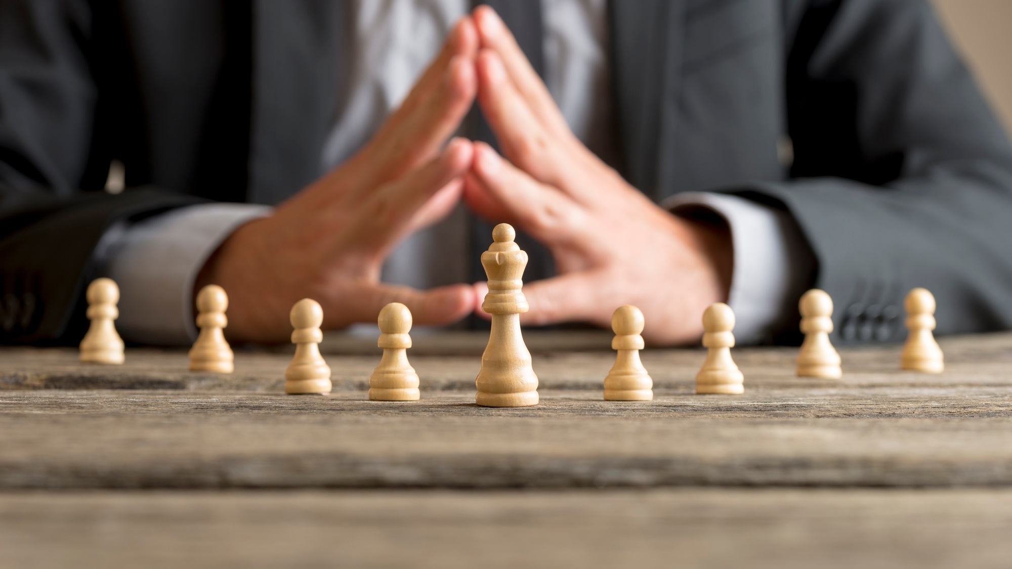 Businessman with clasped hands planning strategy